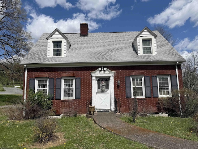 114 N Pike St, Grafton, WV 26354 - new england style home with brick siding, roof with shingles, and a chimney