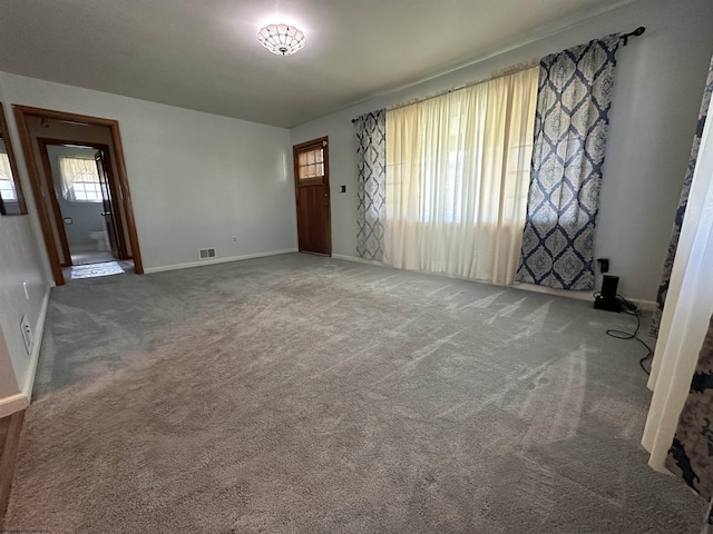 interior space with carpet floors, baseboards, and visible vents