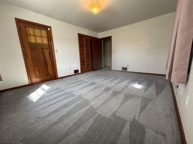unfurnished bedroom with baseboards, light colored carpet, visible vents, and a closet