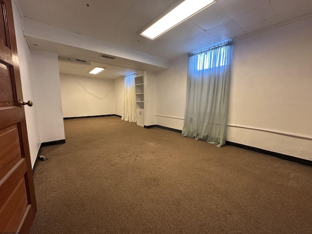 below grade area with carpet floors, baseboards, and visible vents