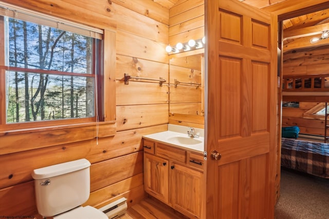 79 Pines Dr, Davis, WV 26260 - ensuite bathroom featuring wooden walls, connected bathroom, vanity, toilet, and a baseboard radiator