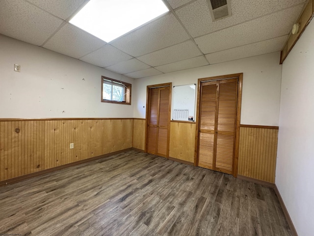 143 Sunday Dr, Fairmont, WV 26554 - empty room with visible vents, wainscoting, wood finished floors, and a paneled ceiling