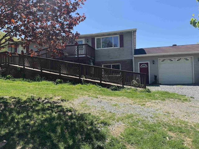 143 Sunday Dr, Fairmont, WV 26554 - exterior space with a garage, gravel driveway, a front yard, a deck, and brick siding