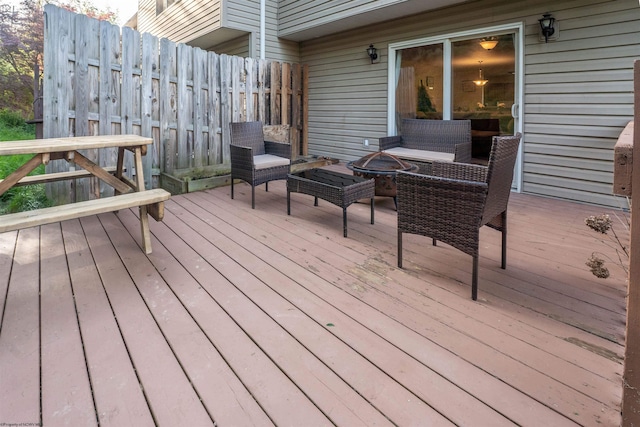 wooden terrace featuring fence and an outdoor fire pit