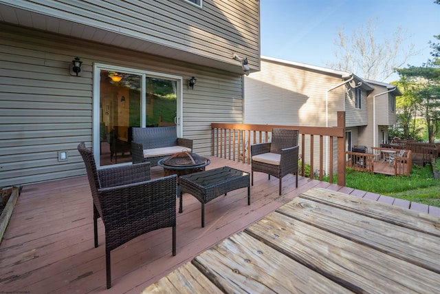 deck featuring an outdoor fire pit