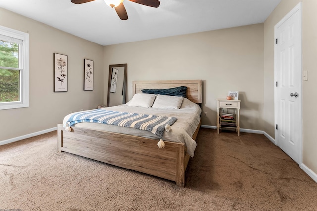 carpeted bedroom featuring baseboards and a ceiling fan