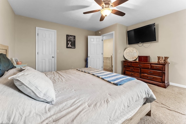 bedroom with carpet floors, a ceiling fan, and baseboards