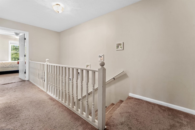 staircase with carpet floors and baseboards