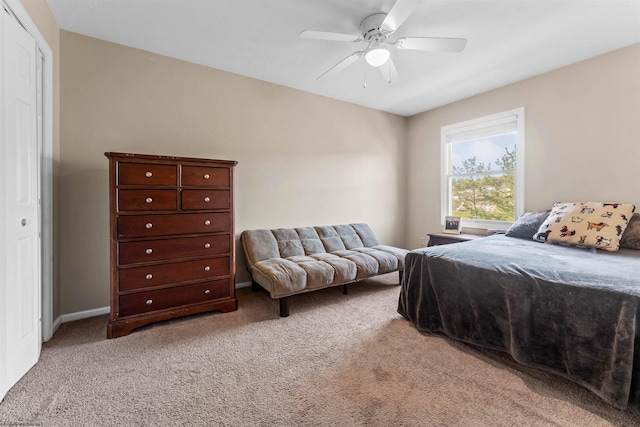 bedroom featuring a ceiling fan and light colored carpet