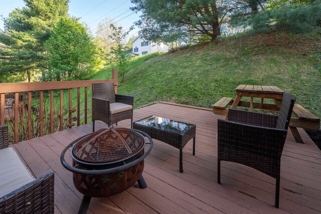 wooden terrace with an outdoor fire pit