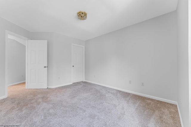 unfurnished bedroom with carpet flooring and baseboards