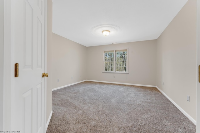 unfurnished room with carpet floors and baseboards