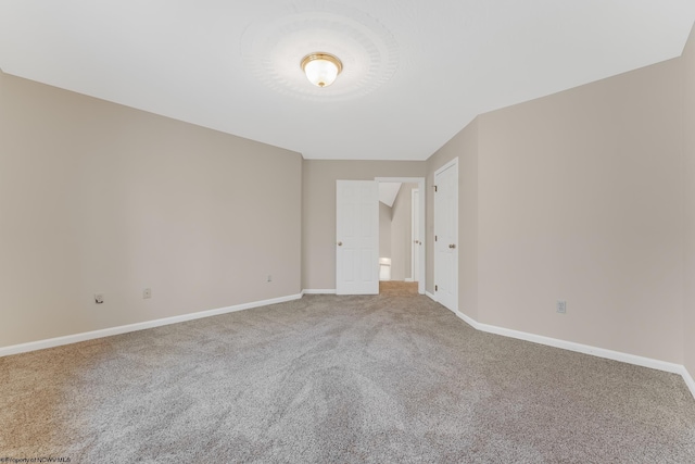 empty room with baseboards and carpet