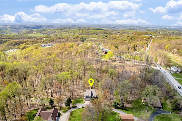 birds eye view of property featuring a view of trees