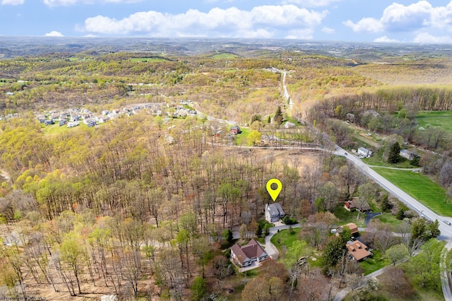 birds eye view of property with a wooded view