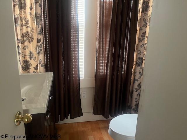 510 6th St, Fairmont, WV 26554 - full bathroom with a sink, wood finished floors, toilet, and curtained shower