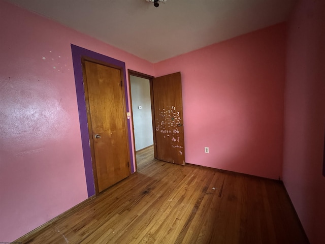 unfurnished bedroom featuring wood finished floors