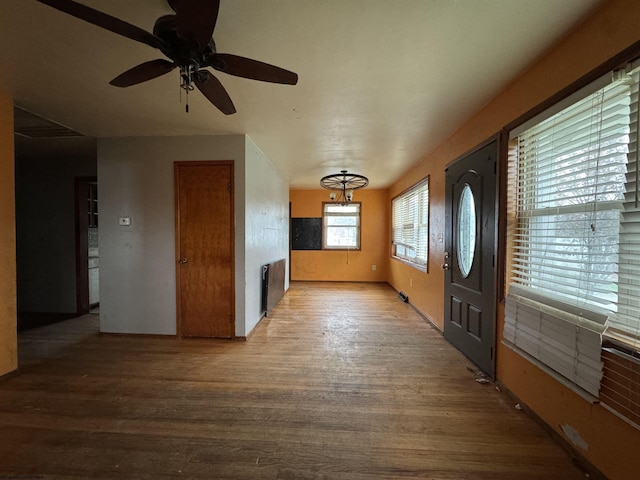 entryway with a ceiling fan, wood finished floors, and radiator heating unit