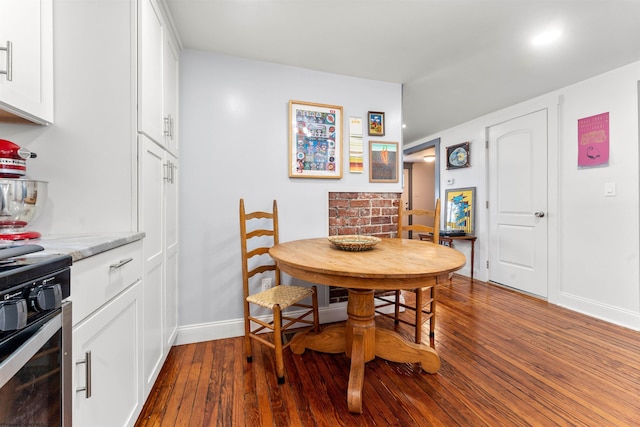 dining space featuring baseboards and dark wood-style flooring