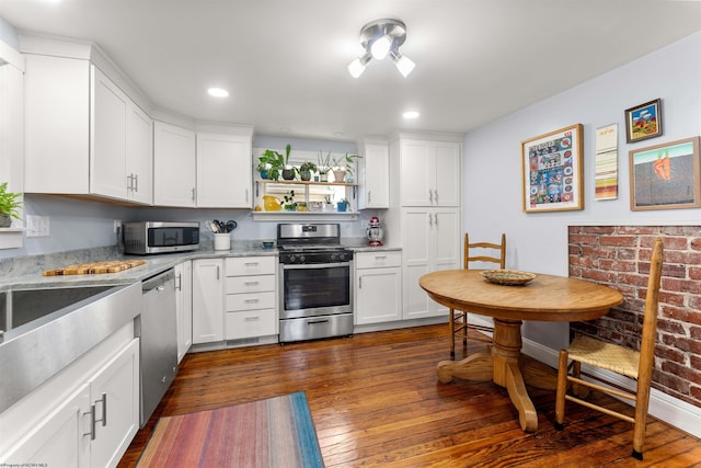 kitchen featuring white cabinetry, appliances with stainless steel finishes, recessed lighting, and dark wood-type flooring