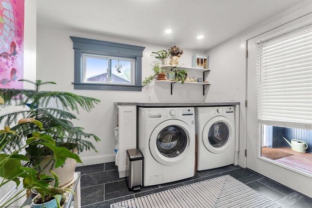 clothes washing area featuring dark tile patterned flooring, laundry area, washing machine and dryer, and recessed lighting