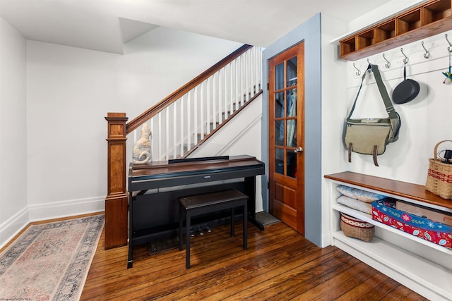sitting room with wood-type flooring, baseboards, and stairway