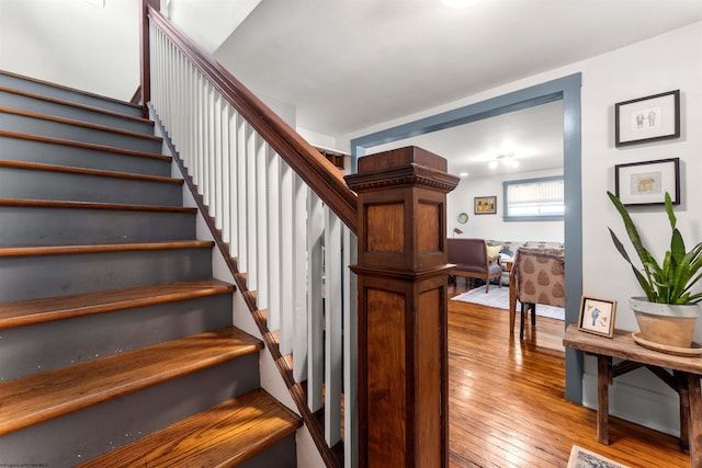stairs featuring wood-type flooring