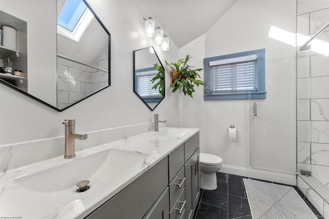 bathroom with double vanity, toilet, a sink, and vaulted ceiling with skylight