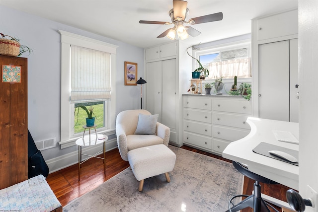 office area with visible vents, baseboards, ceiling fan, and wood finished floors