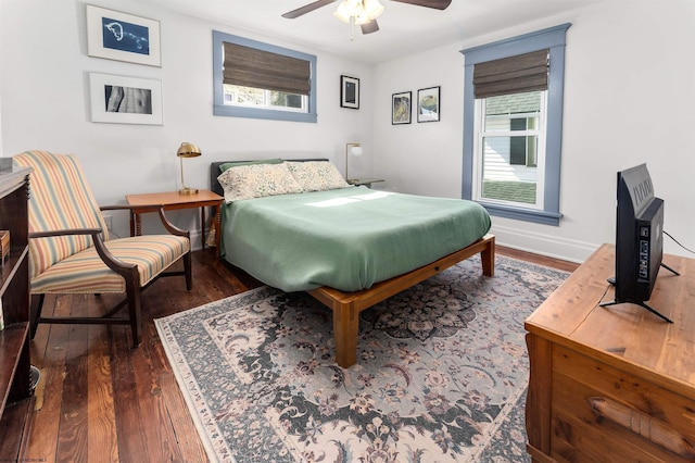 bedroom featuring baseboards, ceiling fan, and dark wood-type flooring
