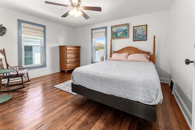 bedroom with baseboards, wood-type flooring, a ceiling fan, and visible vents
