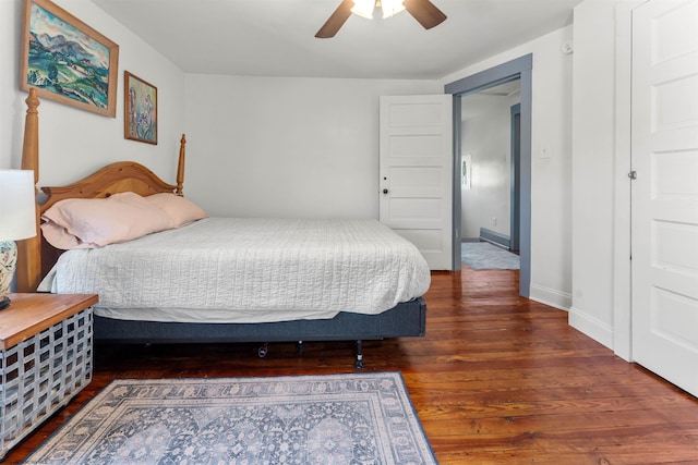 bedroom with baseboards, ceiling fan, and wood finished floors
