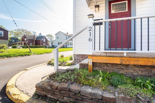 entrance to property featuring a residential view