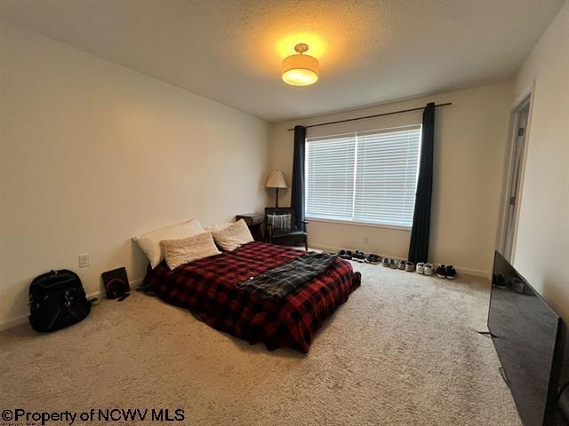 carpeted bedroom with baseboards