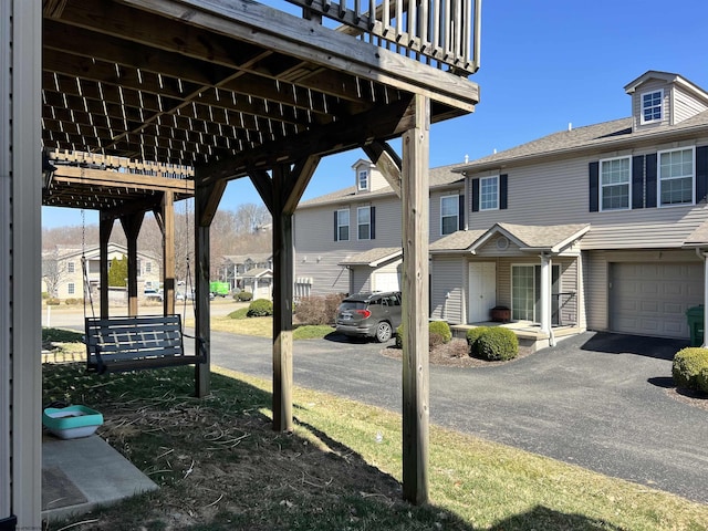 view of patio / terrace featuring a residential view and an attached garage
