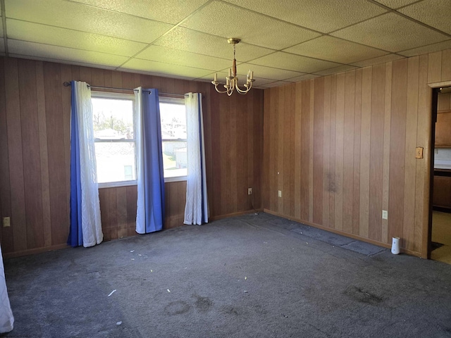 130 Hunsaker St, Fairmont, WV 26554 - empty room featuring an inviting chandelier, carpet floors, baseboards, and wood walls