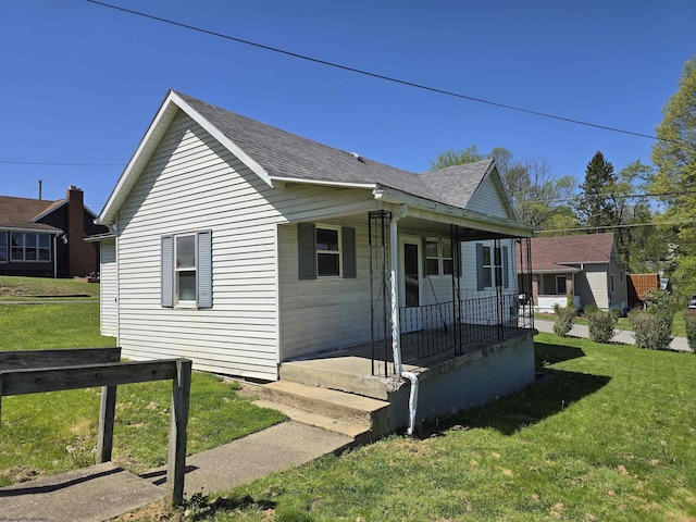 130 Hunsaker St, Fairmont, WV 26554 - bungalow featuring covered porch, a shingled roof, and a front yard