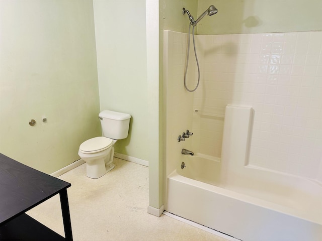 full bath featuring baseboards, toilet, and shower / washtub combination