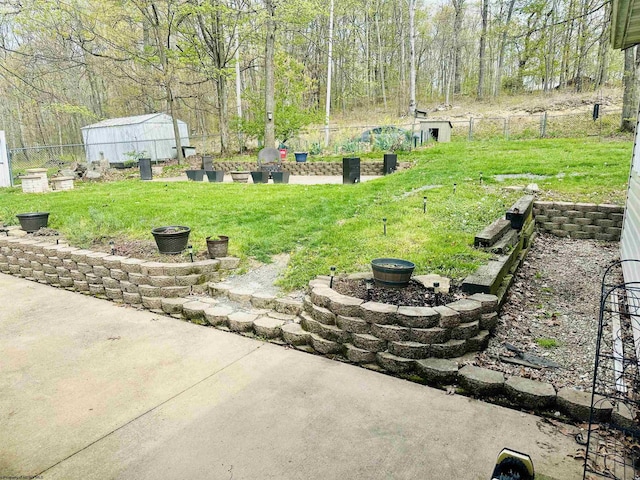 view of yard featuring fence, a patio area, and an outdoor fire pit