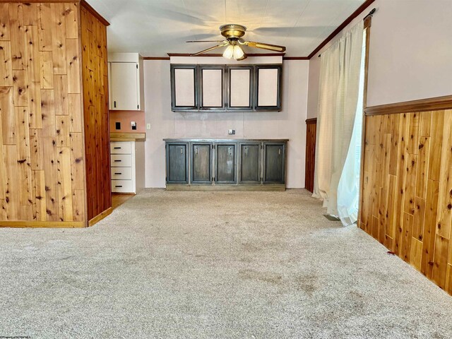 108 Toothman Run Rd, Rivesville, WV 26588 - unfurnished living room featuring carpet flooring, ceiling fan, wooden walls, and ornamental molding