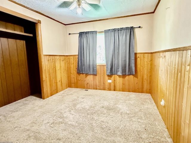 108 Toothman Run Rd, Rivesville, WV 26588 - unfurnished bedroom featuring wood walls, ornamental molding, carpet, and a wainscoted wall