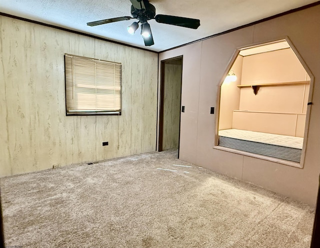 108 Toothman Run Rd, Rivesville, WV 26588 - spare room featuring carpet floors, crown molding, wooden walls, and ceiling fan