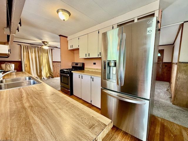 108 Toothman Run Rd, Rivesville, WV 26588 - kitchen with white cabinets, appliances with stainless steel finishes, a sink, and light wood-type flooring