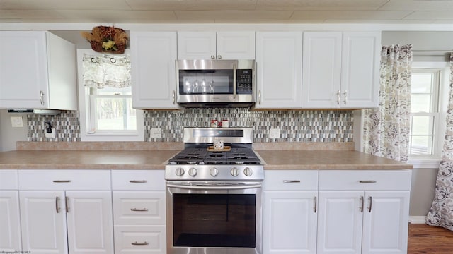 kitchen featuring light countertops, stainless steel appliances, and white cabinets