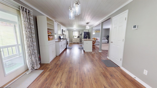 interior space featuring white cabinets, stainless steel appliances, open shelves, and dark wood-type flooring