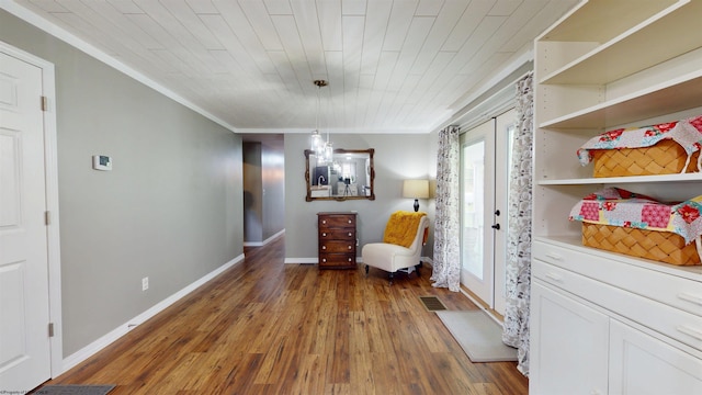 sitting room featuring crown molding, baseboards, and hardwood / wood-style floors