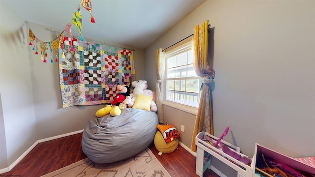 playroom featuring baseboards and wood finished floors