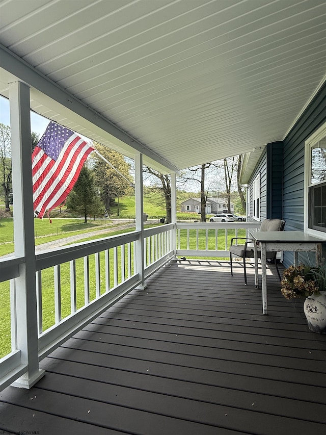 wooden deck with a porch and a yard