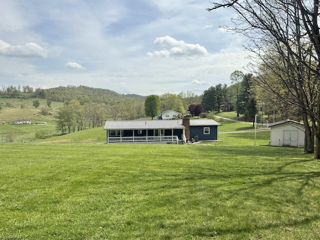 exterior space with a lawn, a shed, and an outbuilding