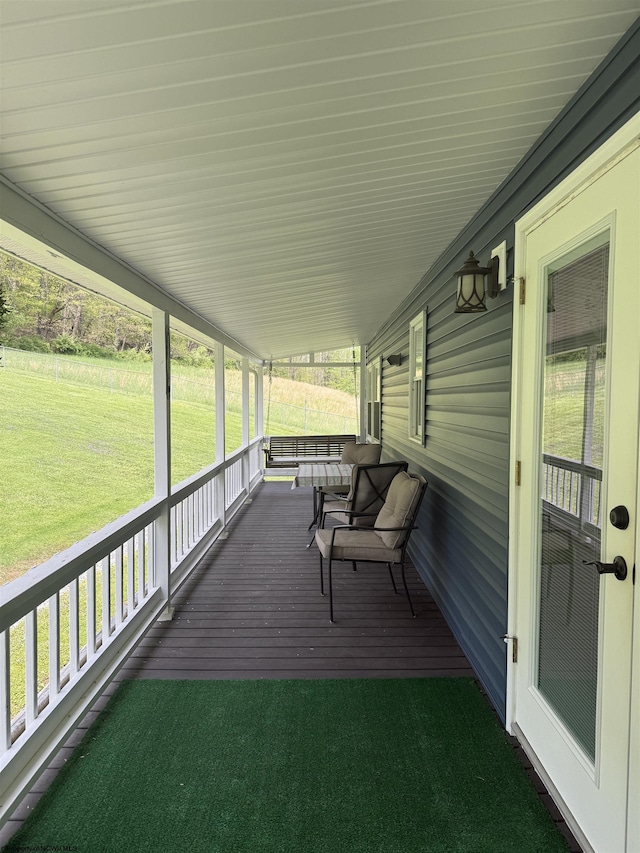 wooden deck with a yard and covered porch